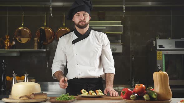Portrait of Positive Chef in Apron Smiling at Camera During Work