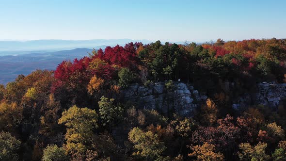 An aerial shot of a man standing on Tibbet Knob, part of Great North Mountain, the border between Vi alt