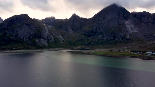 Flying over the ocean at the coast of Norway, Lofoten looking at the mountains in clouds in the back alt