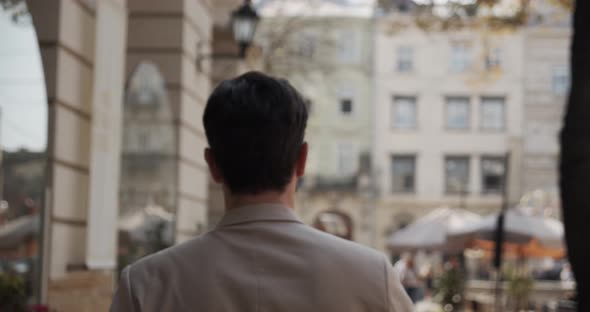 Young Man Walks Around The City Looking Around alt