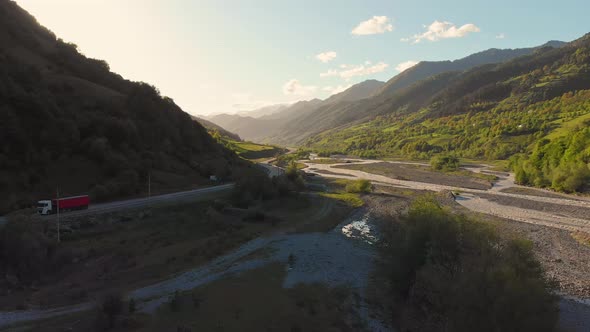 Rising View Over Valley With Passing Truck In K Azbegi National Park alt