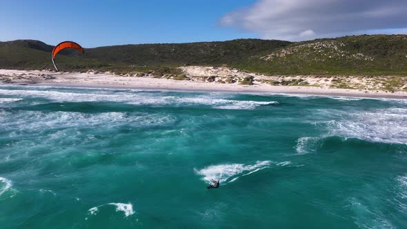 Slomo shot of daring kitesurfer launching off a wave and landing it; Cape Point alt