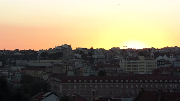 The Beautiful Setting Sun Behind The Peaceful City Of Lisbon, Portugal