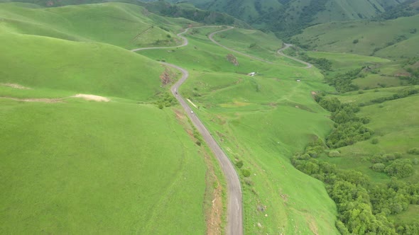 Cars passing through curve in mountainous road. Mountain serpentine road