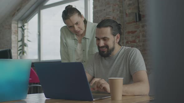 Friends are Working Together on a Common Project Smiling and Laughing alt