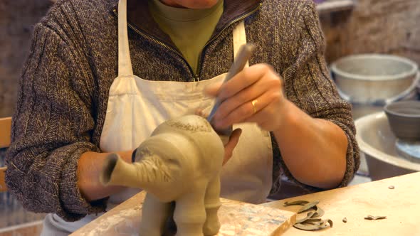 Potter working on clay sculpture alt