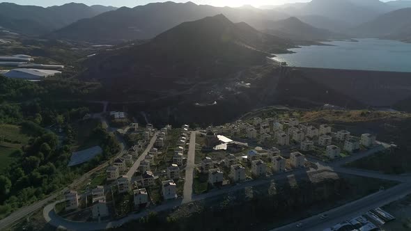 Mountains Buildings And Dam Aerial View
