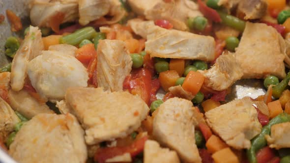 Tasty lunch preparing in frying pan close-up 4K 2160p 30fps UltraHD video - Colorful mix of frozen v alt