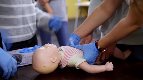 Newborn resuscitation on an infant dummy doll.  alt