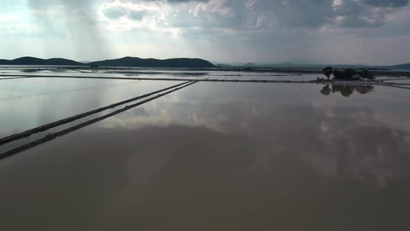 Alykes the Hellenic saltworks located outside of Mesolongi in Greece. Drone footage with the clouds alt