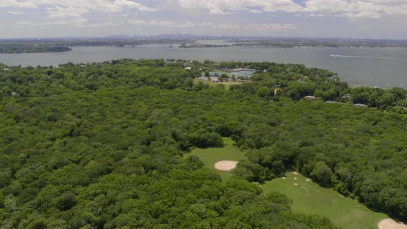 Aerial View of a Long Island Village by the Water and NYC Skyline Seen from Afar alt