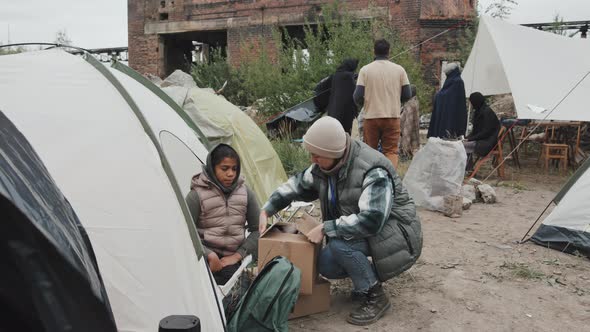 Social Workers Helping People at Refugee Camp alt