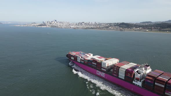 Big Commercial Ship is crossing the Bay + San Francisco skyline is in the background