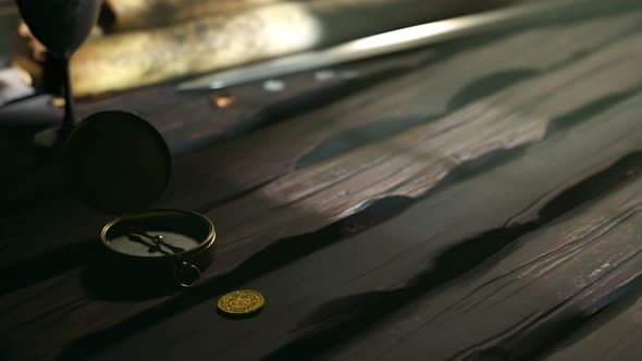 Hand-drawn ancient map with animated drawings rolls out on the wooden table alt