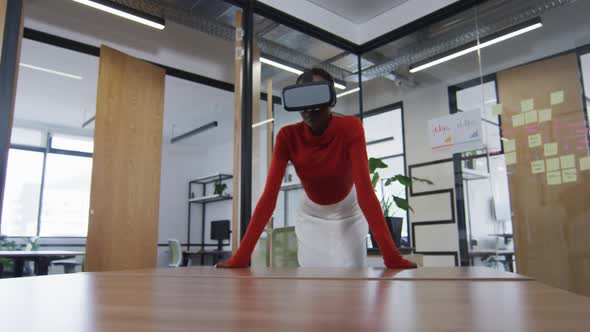 African american woman wearing vr headset at modern office alt