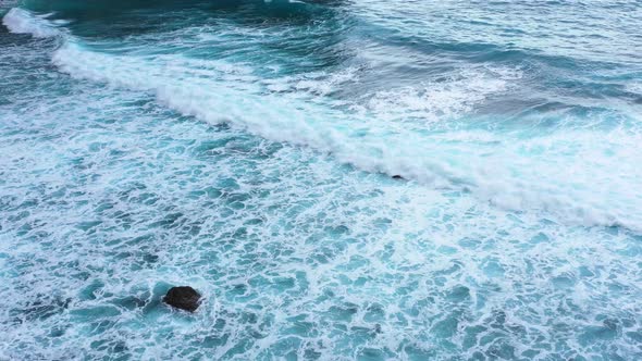 Indonesia. Waves and azure water as a background. View from drone at the ocean surface.  alt