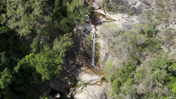 Visitors enjoying the crystal clear and warm waters of Fecha de Barjas waterfall, Peneda-Gerês