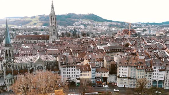 Aerial slide Pan over Cathedral of Bern and City Center, Switzerland alt