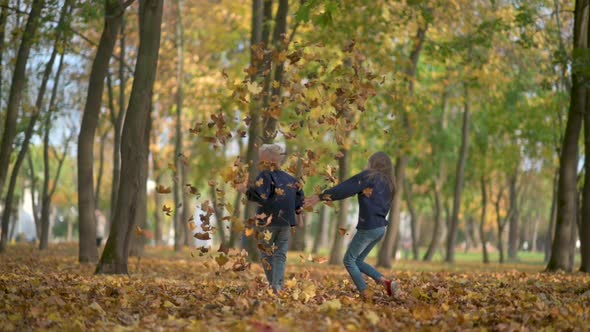 Happy Children Play in the Autumn Park.