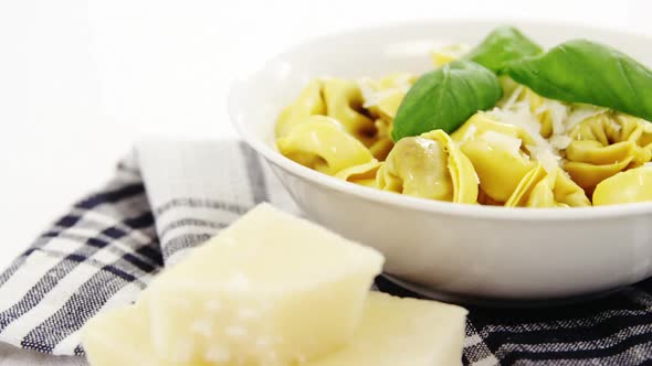 Bowl of cooked pasta with cheese alt