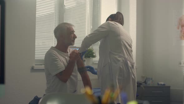 Physician Vaccinate Elderly Patient in Hospital alt