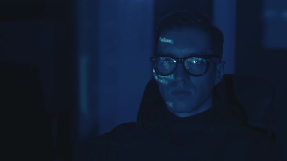 Portrait of IT Hacker Programmer Developer in Eyeglasses Working Computer Cyber Attack on Server at alt