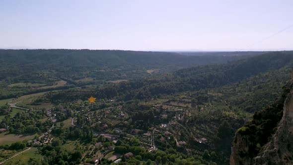 Golden star hanging between cliffs in Moustiers-Sainte-Marie village, France alt
