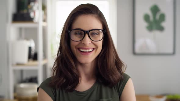 Close up video portrait of happy woman with eyeglasses. Shot with RED helium camera in 8K. alt