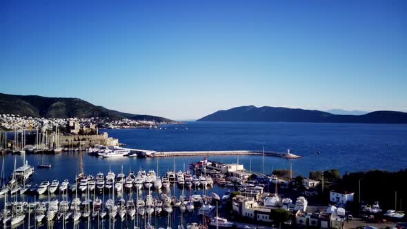 View from drone on full of yachts Bodrum harbour and ancient Kalesi castle in Mugla in Turkey alt