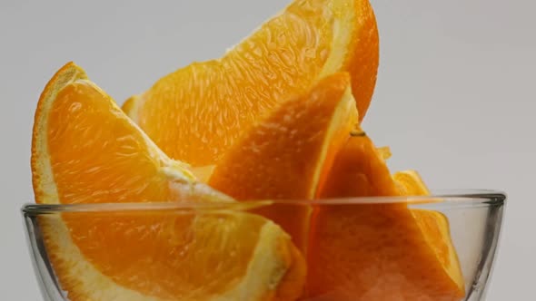 Slices Of Orange Lie In A Glass Bowl That Rotates