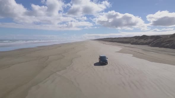 Aerial footage of driving car on the beach