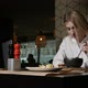 a Young Blonde Woman Eating Soup Sitting in a Restaurant - VideoHive Item for Sale