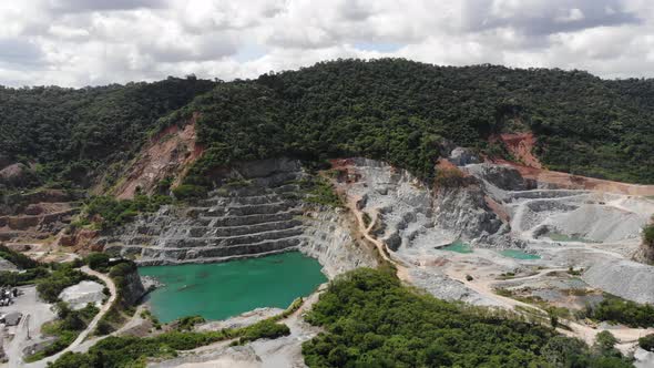 Aerial view of opencast mining quarry with big pool. Aerial view from drone shoot alt