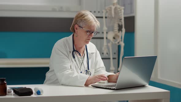 Portrait of General Practitioner Working on Laptop in Medical Office alt