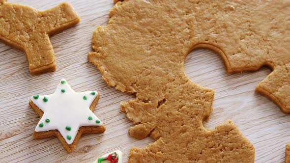 Gingerbread dough with star shapes on wooden table 4k alt