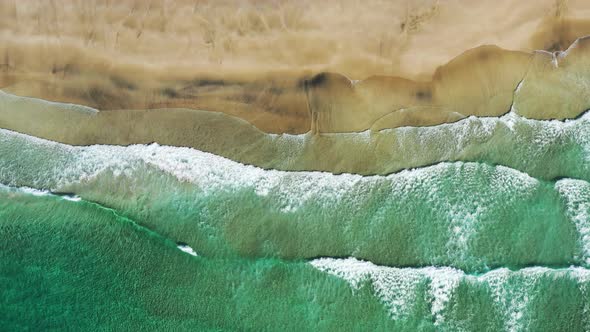 Aerial view on the Lofoten beach with splashing sea waves