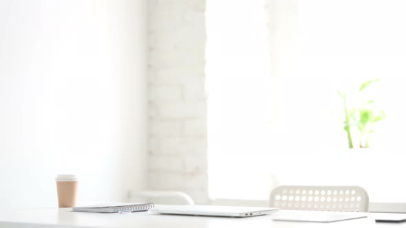 Man Coming Back Opening Laptop in Office alt