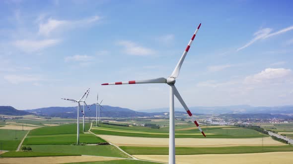 Aerial flight near wind turbines. Renewable Clear energy production. Farm landscape. Drone footage