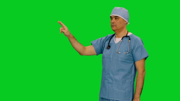 Medic Makes Different Hand Gestures through a Virtual Display on Green Screen 