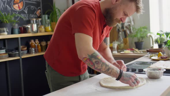 Chef Flattening Dough for Baking Pizza alt