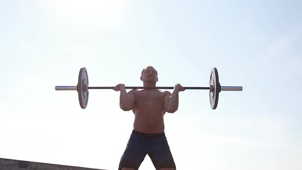 Athlete Training with Barbell . Slow Motion.
