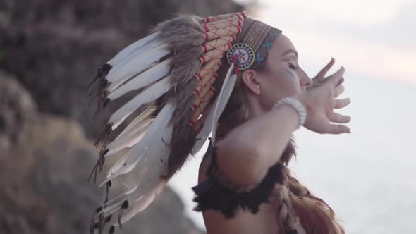 Mysterious Woman with Feather Hat and Colourful Makeup Ceremonial Shaman Dancing Culture Concept