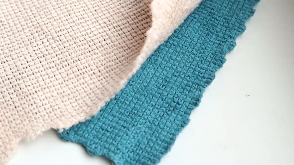 4k video, Blue and beige microfiber cleaning cloth, highlighted on a white background, Close-up view