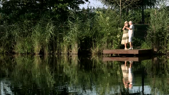 Senior People Dancing on Nature Background. alt