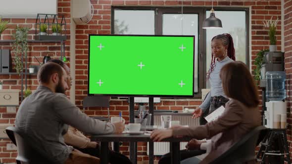 Business People Doing Presentation with Green Screen on Monitor alt