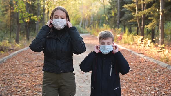 Mother and Son Take Off Medical Masks and Smile