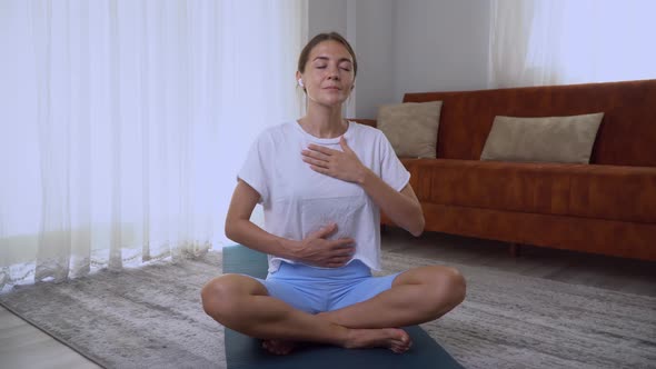 A Woman Does the Practice of Mindful Breathing at Home Meditation with Breathing