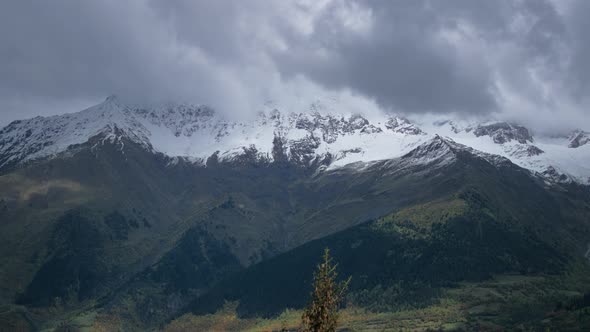 Snowy mountains covered in stormy clouds