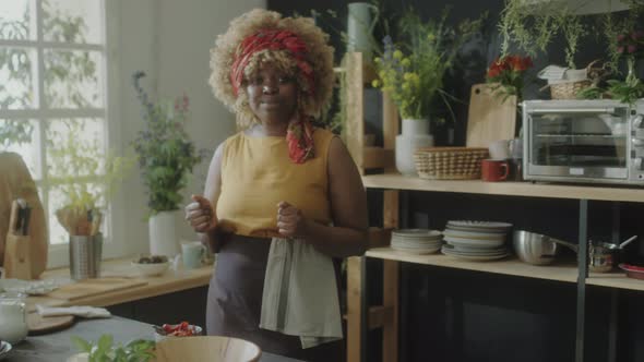 African American Woman Filming Vlog in Kitchen alt