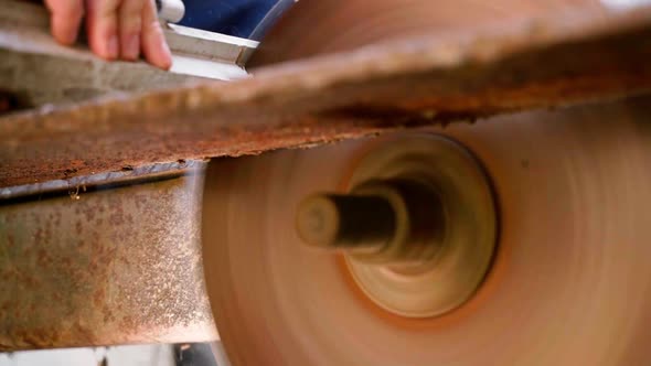 A Man Cuts Wooden Parts on an Old Circular Machine alt